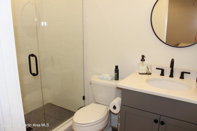 bathroom with vanity, toilet, and walk in shower