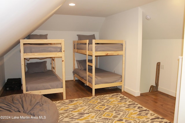 bedroom with hardwood / wood-style flooring and vaulted ceiling