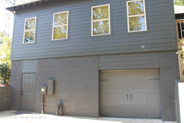 back of house featuring a garage