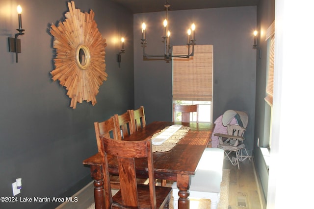 dining room featuring hardwood / wood-style floors and a notable chandelier