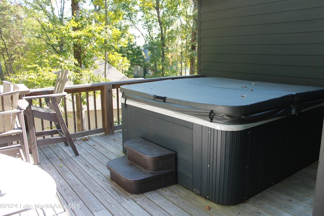 wooden deck featuring a hot tub