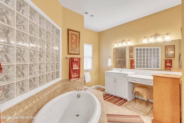 bathroom with tile patterned flooring, visible vents, vanity, and a whirlpool tub