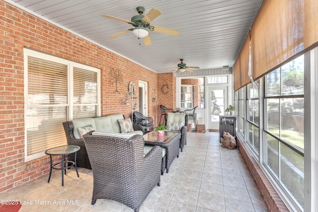 sunroom / solarium with a ceiling fan