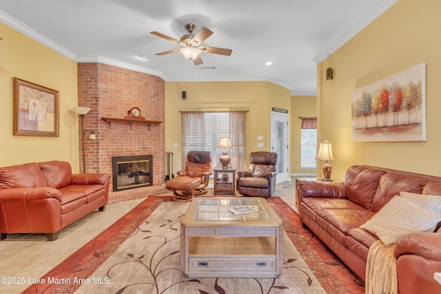 living area featuring light tile patterned floors, recessed lighting, ornamental molding, ceiling fan, and a brick fireplace