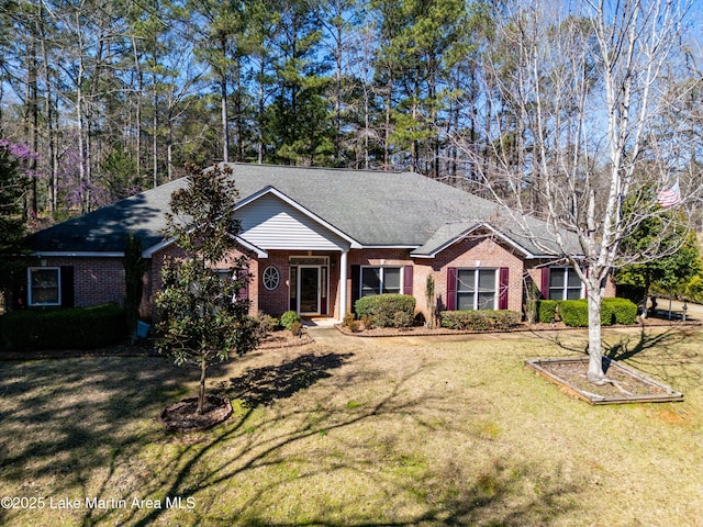 ranch-style home featuring a front lawn, brick siding, and a shingled roof