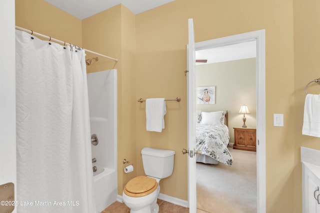 bathroom featuring baseboards, ensuite bath, tile patterned flooring, shower / bath combo with shower curtain, and toilet