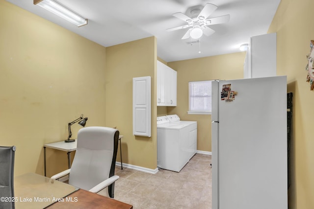 office space with light tile patterned floors, a ceiling fan, independent washer and dryer, and baseboards