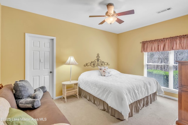 bedroom featuring visible vents, carpet floors, baseboards, and a ceiling fan