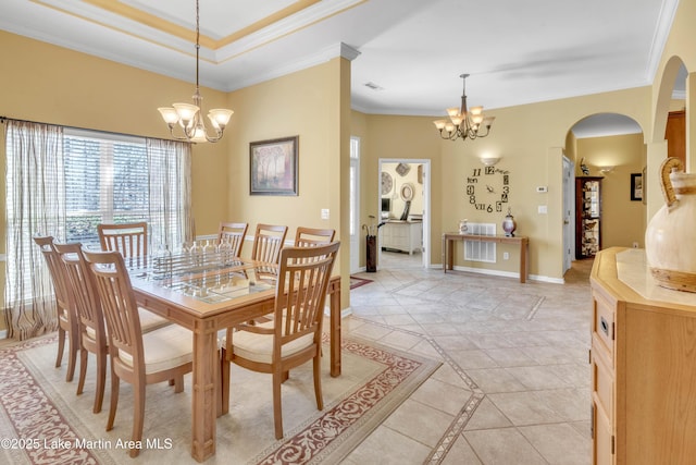 dining area with a chandelier, arched walkways, baseboards, and ornamental molding