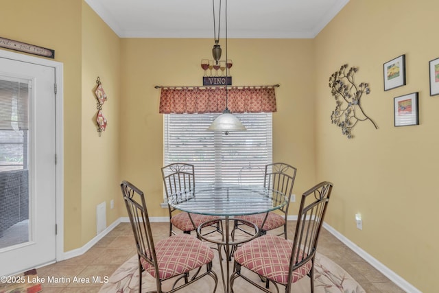 dining area with baseboards, light tile patterned flooring, and ornamental molding