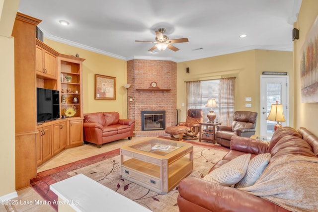 living area with light tile patterned flooring, a brick fireplace, ornamental molding, and a ceiling fan