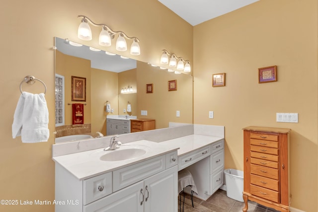 bathroom with vanity, tile patterned floors, and a bathtub