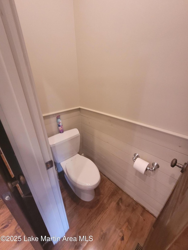 bathroom with toilet and hardwood / wood-style flooring