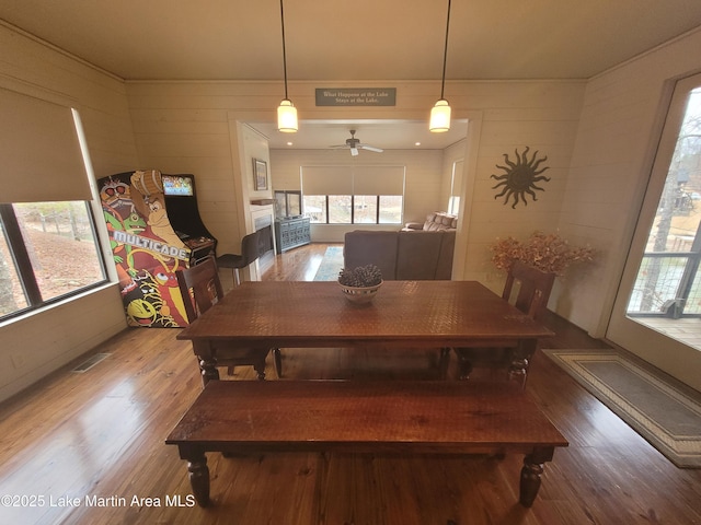 dining space with ceiling fan and hardwood / wood-style floors