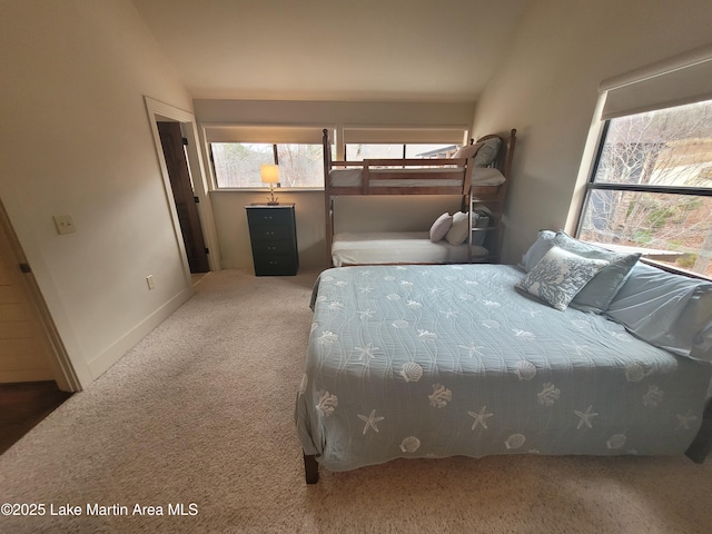 carpeted bedroom with vaulted ceiling