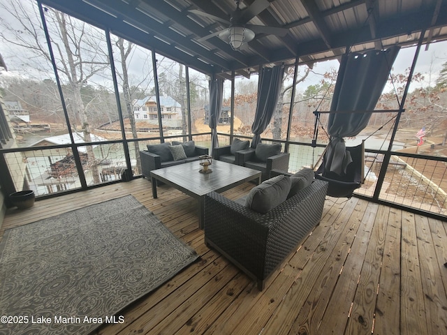 wooden terrace with an outdoor living space and ceiling fan