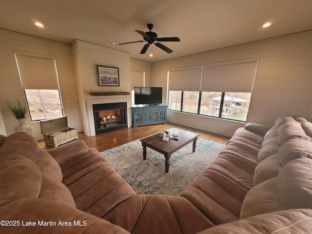 living room featuring hardwood / wood-style flooring and ceiling fan