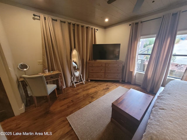 bedroom with ceiling fan, dark hardwood / wood-style flooring, and wooden ceiling