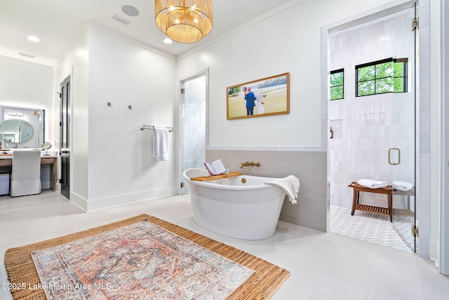 bathroom with visible vents, tile walls, a stall shower, an inviting chandelier, and a soaking tub