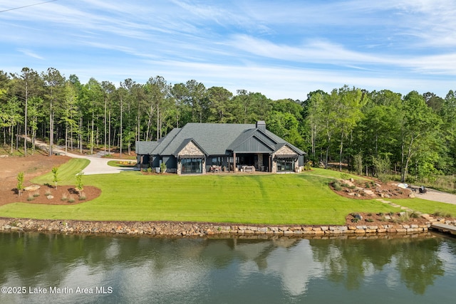 exterior space with a water view and a forest view