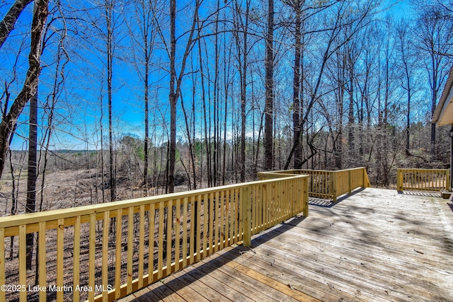 wooden terrace with a wooded view