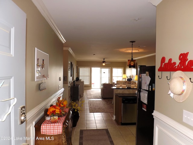 kitchen featuring black fridge, stainless steel dishwasher, ceiling fan, crown molding, and light tile patterned floors