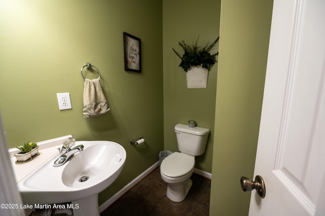 bathroom featuring tile patterned flooring, sink, and toilet