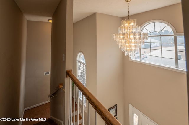 hall featuring a chandelier