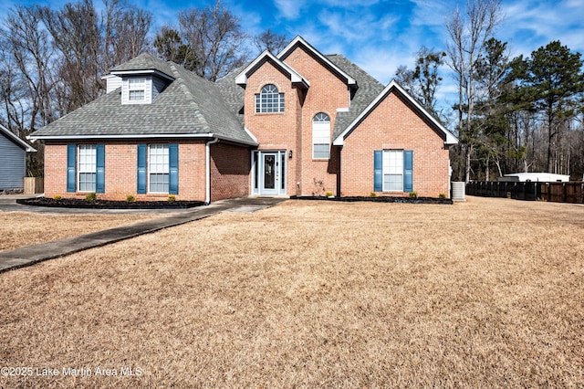 view of front property with central AC and a front yard