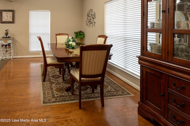 dining space with wood-type flooring