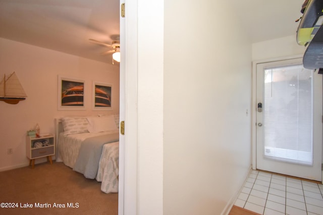 bedroom with ceiling fan and light tile patterned flooring