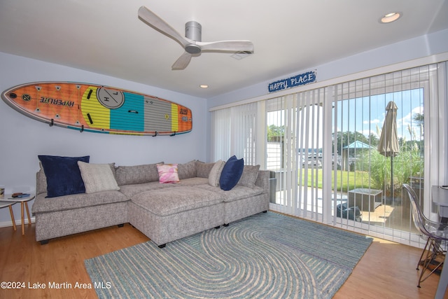 living room featuring hardwood / wood-style flooring and ceiling fan