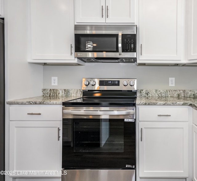 kitchen with stainless steel appliances and white cabinetry