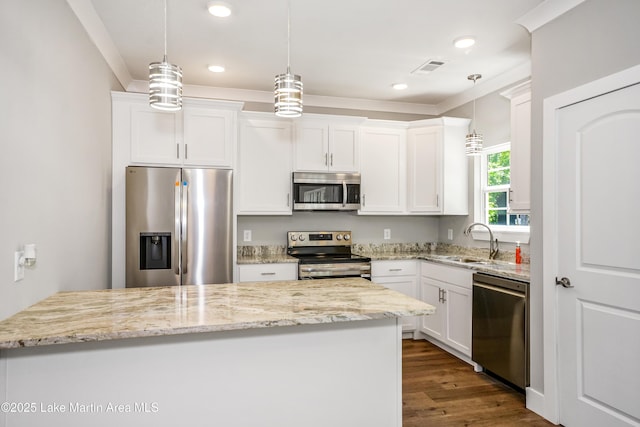 kitchen featuring appliances with stainless steel finishes, white cabinetry, dark wood-style floors, light stone counters, and recessed lighting