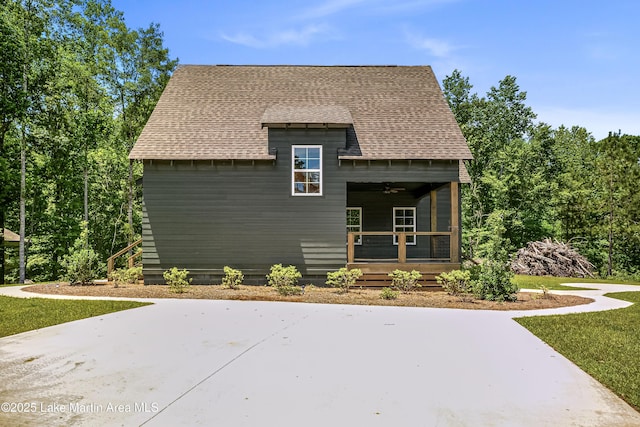 view of side of property featuring roof with shingles