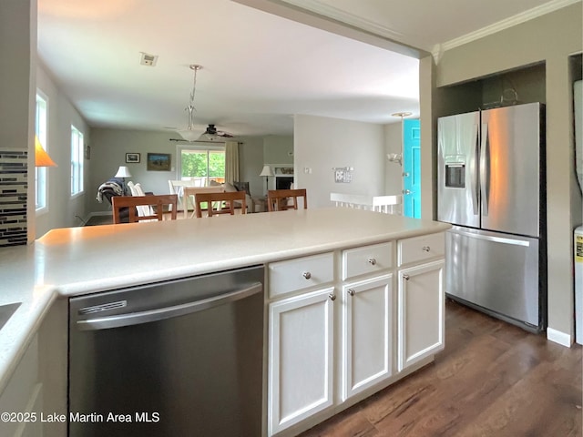 11 Redbud Ct, Dadeville, AL 36853 - kitchen featuring appliances with stainless steel finishes, a ceiling fan, white cabinetry, dark wood finished floors, and crown molding