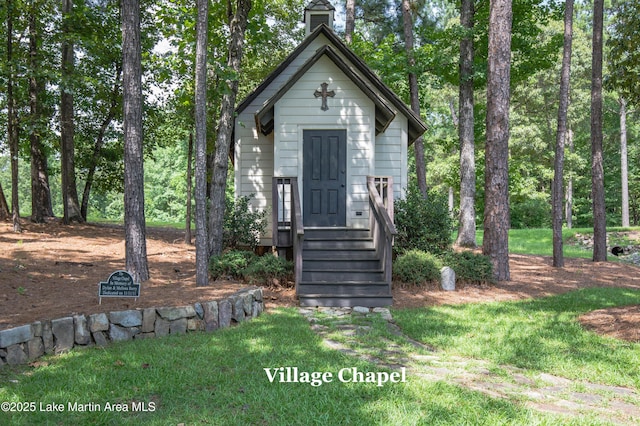 view of outbuilding with a yard