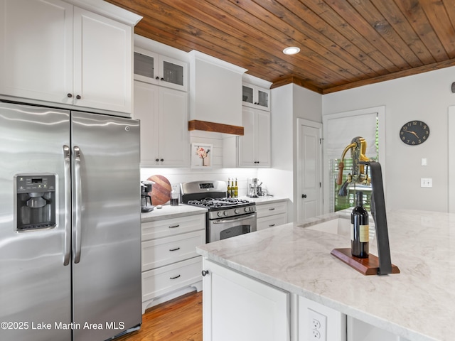 kitchen with white cabinetry, stainless steel appliances, light stone countertops, ornamental molding, and wooden ceiling