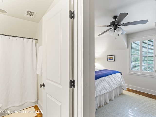 bedroom with ceiling fan and wood-type flooring