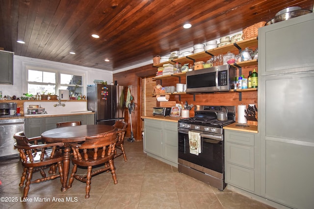 kitchen with stainless steel appliances, light tile patterned flooring, and wooden ceiling