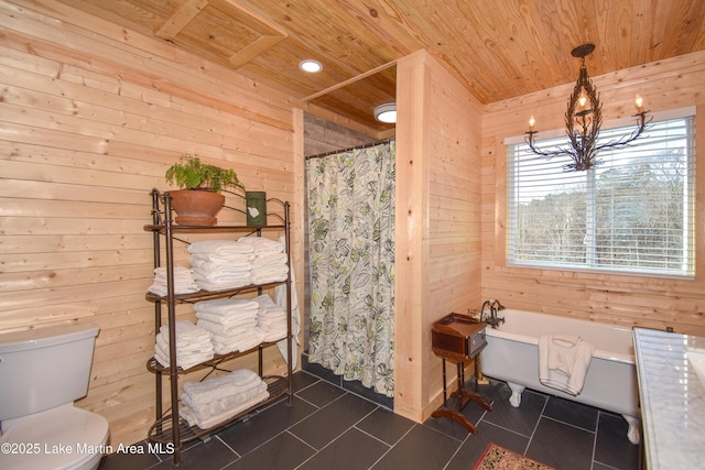 bathroom featuring toilet, wood ceiling, wooden walls, a bathtub, and tile patterned flooring