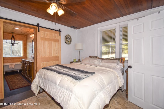 bedroom with wood ceiling, a barn door, and multiple windows