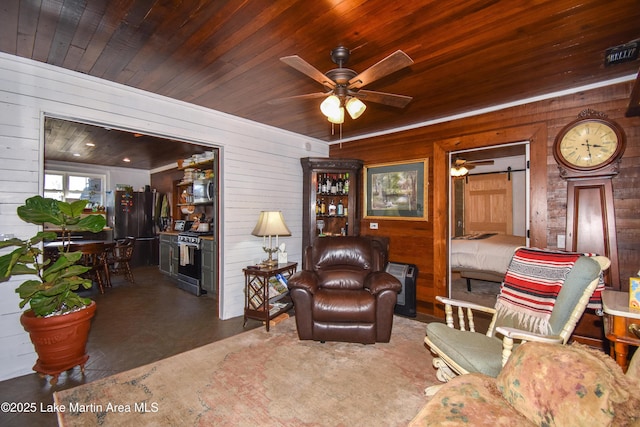 living room featuring wood ceiling, ceiling fan, and wooden walls