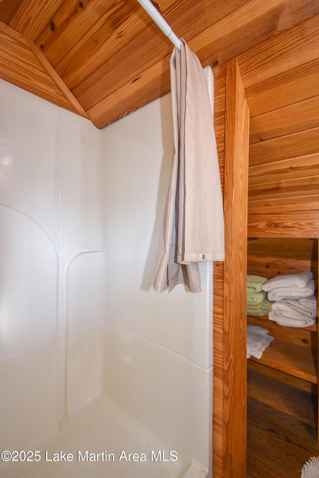 bathroom with walk in shower, lofted ceiling, and wooden ceiling