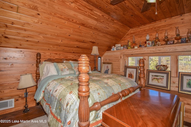 bedroom featuring wood ceiling, vaulted ceiling, and wood walls