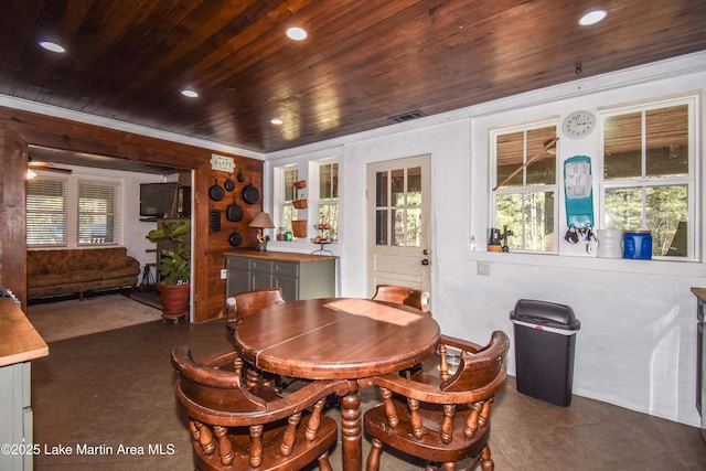 tiled dining space featuring a wealth of natural light and wooden ceiling