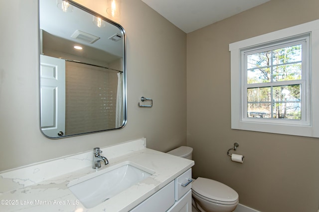 bathroom featuring vanity and toilet