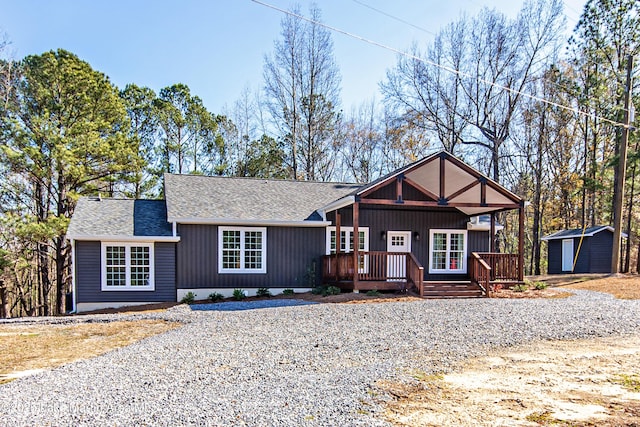 view of front of home featuring a storage shed