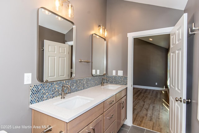 bathroom with tile patterned flooring, vanity, and backsplash