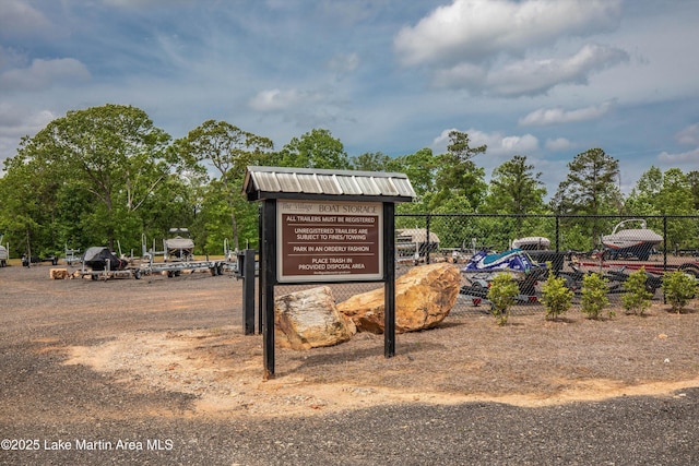 view of home's community featuring fence